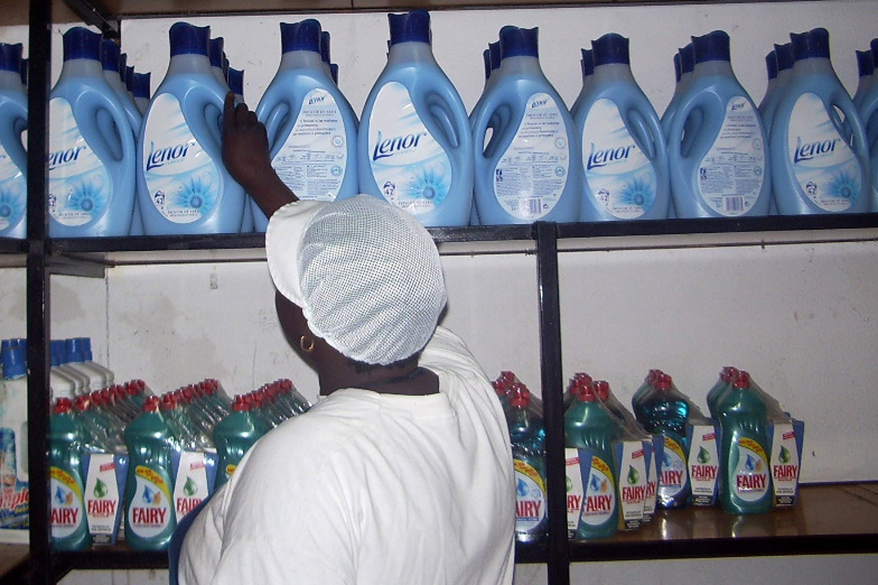 Una treballadora ordenant les ampolles de detergent.